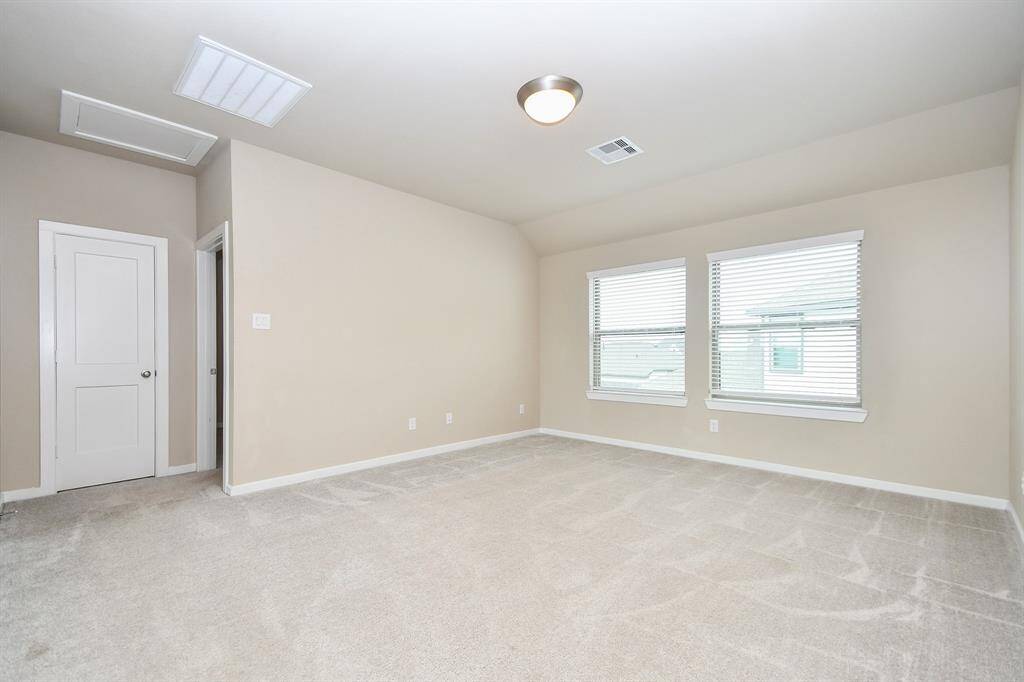The game room is a spacious and versatile retreat, perfect for entertainment and relaxation. With high ceilings and large windows, the room is filled with natural light, creating an inviting atmosphere. Whether used for a media setup, pool table, or gaming station, this flexible space offers endless possibilities for fun and leisure.
