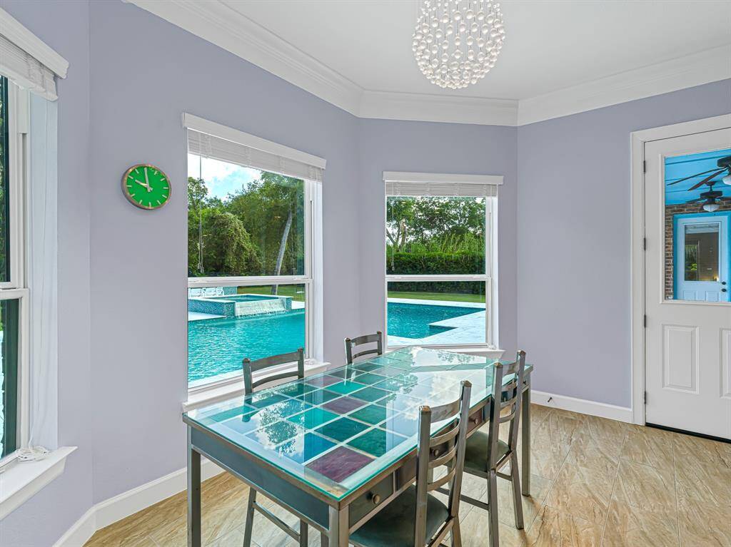 Breakfast room connected to kitchen with access to pool
