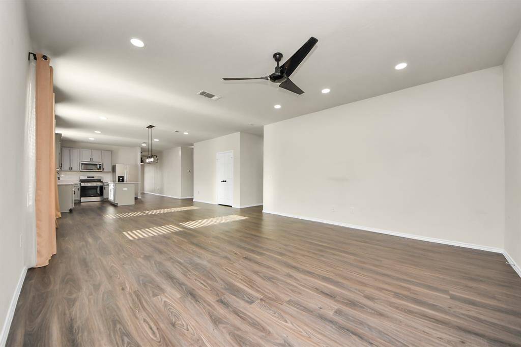 Expansive Living Area; Perfect for family gatherings. Recessed light additions. Stylish ceiling fans ensure comfort in key spaces.