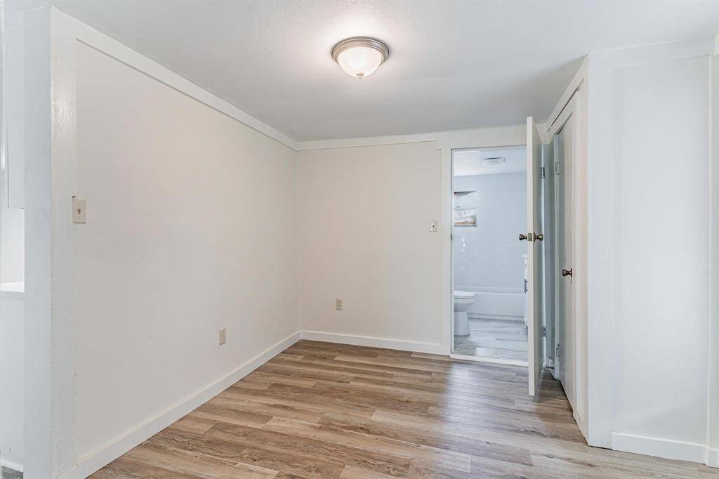 Bright and inviting living area with stylish flooring, ready for your personal touch.
