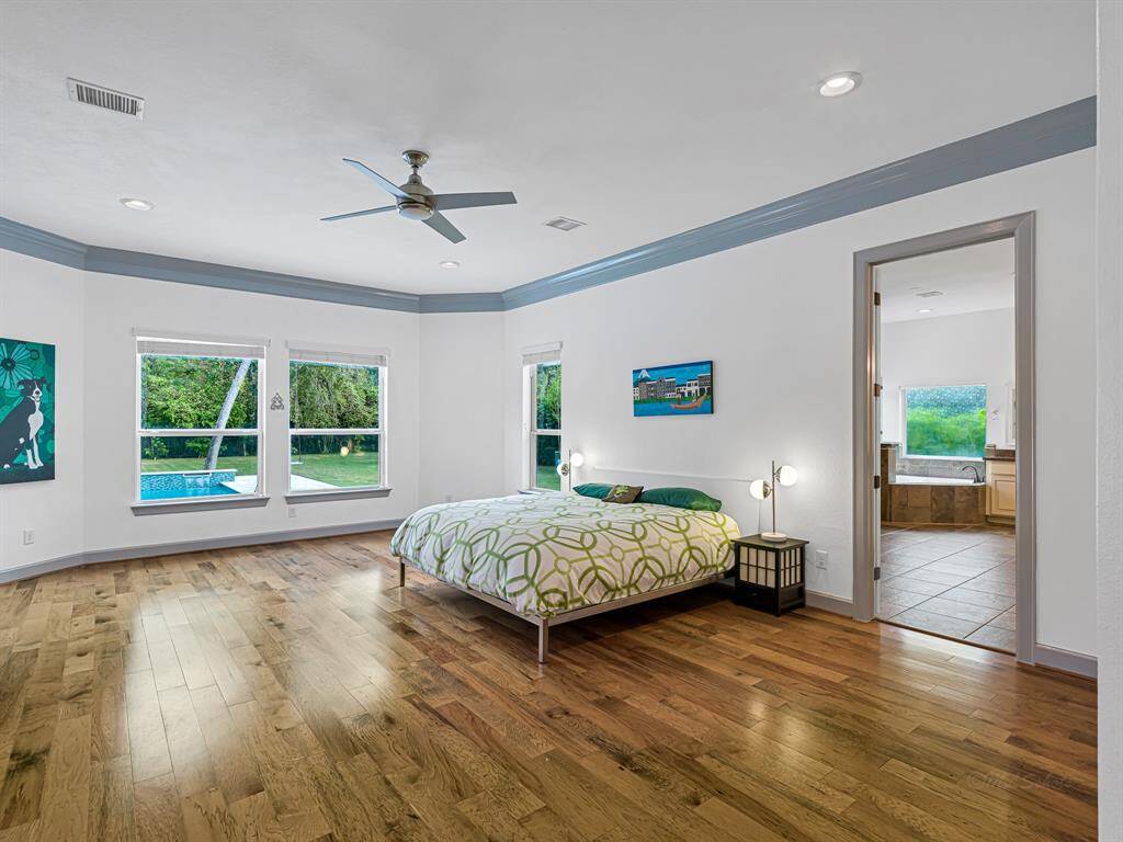 Enormous primary bedroom with beautiful views and private access to the pool and spa.