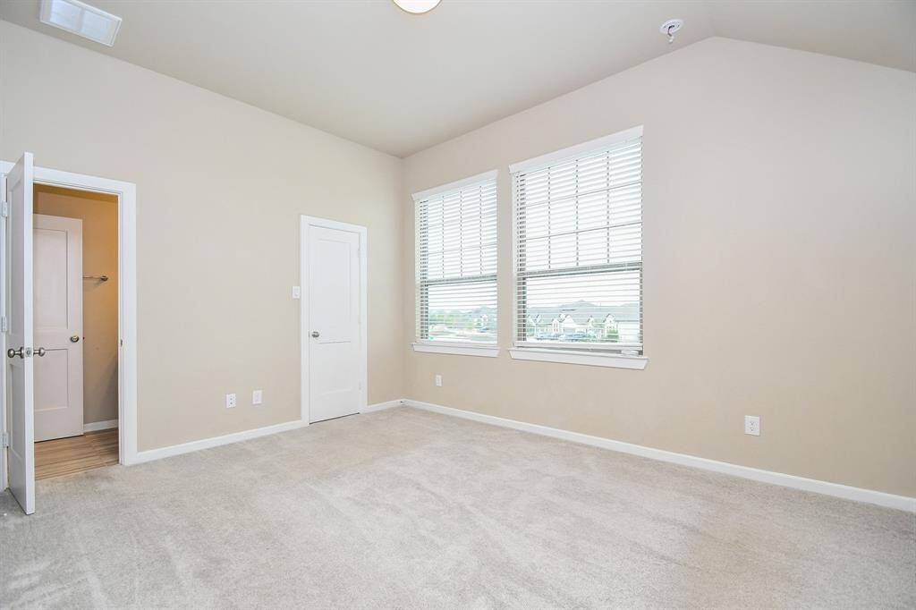 The third upstairs bedroom is a cozy and inviting space, featuring a large window that fills the room with natural light. With plush carpeting and a spacious closet, it offers comfort and functionality. Perfect for a guest room, home office, or personal retreat, this versatile space provides a peaceful ambiance.