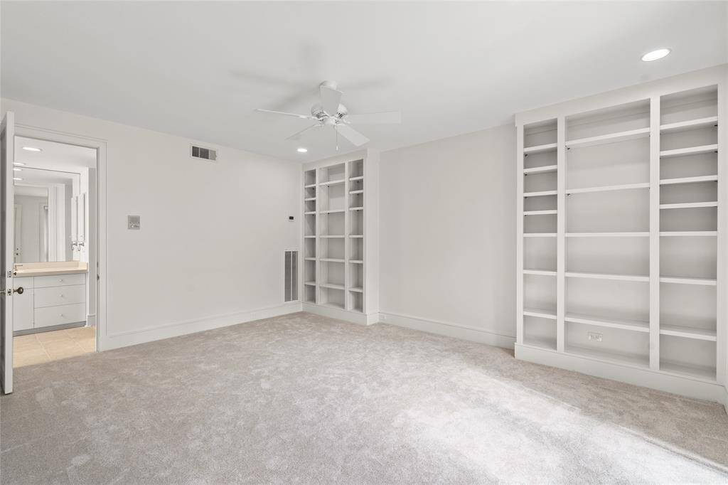 Spacious master bedroom with expansive built in shelving/bookcases on either side of the bed recess.  Note new ceiling fans throughout as well.  Carpet was just replaced in the master bedroom and closet.
