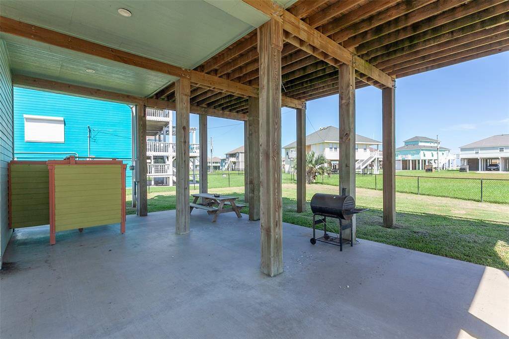 Concrete outdoor living space has a shower so sand can stay outside.