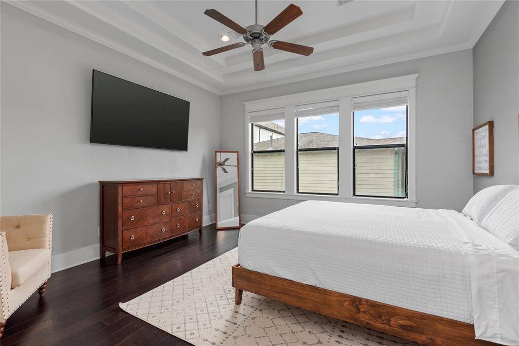 A luxurious primary bedroom featuring ample space, natural light, and sophisticated finishes.