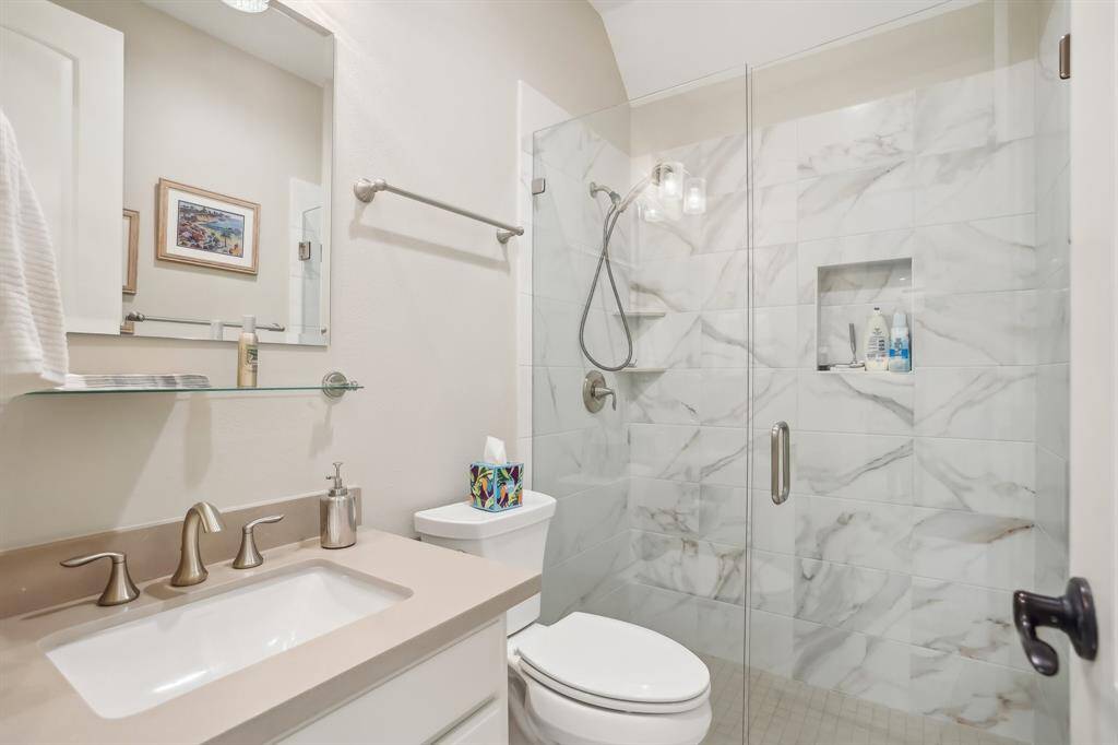 This secondary bath features large walk-in shower.