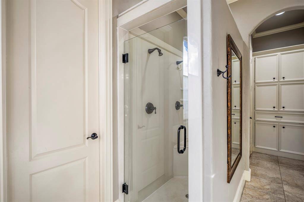 The primary bathroom also offers a separate glass door shower.