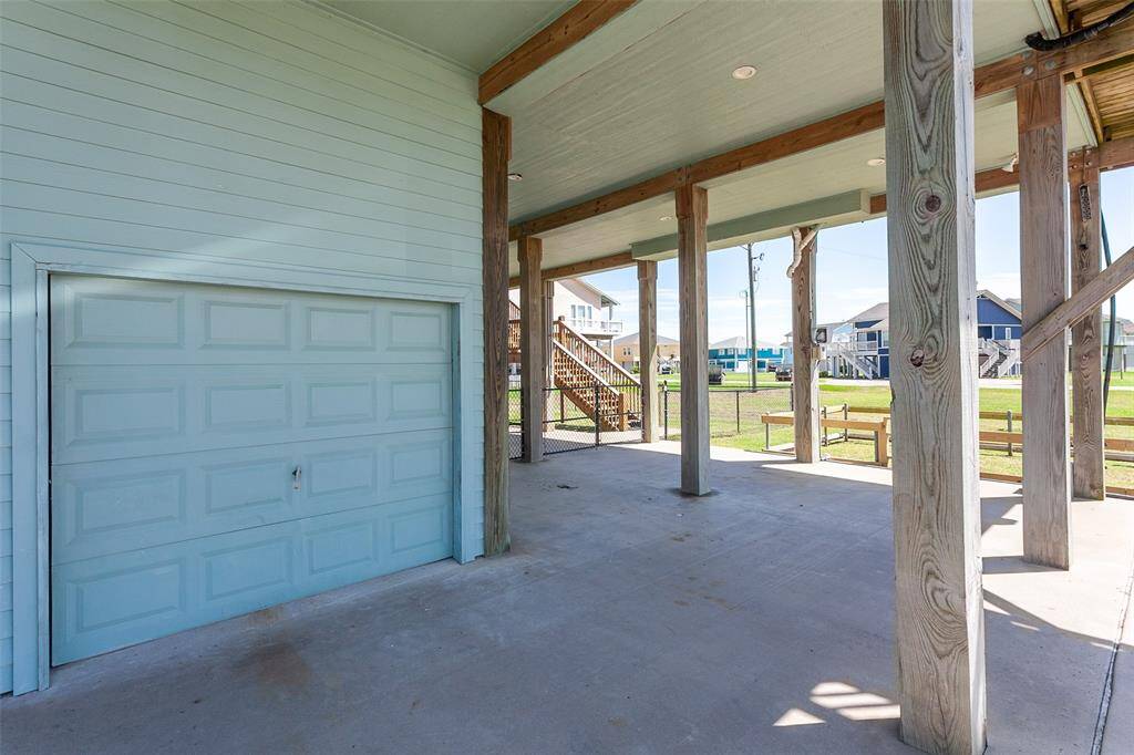 One car garage has a loft space, a little work area and shelves for storage.