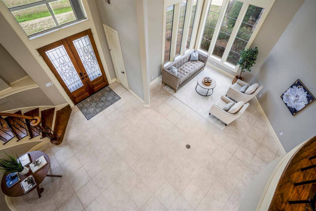 Looking down into the foyer of the home that shows how much space and the light and brightness of the home.