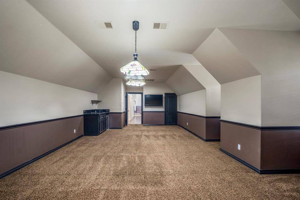 There is space for a large pool table, the lighting is already in place, if you so choose, two toned paint and an angle ceiling create the perfect backdrop.