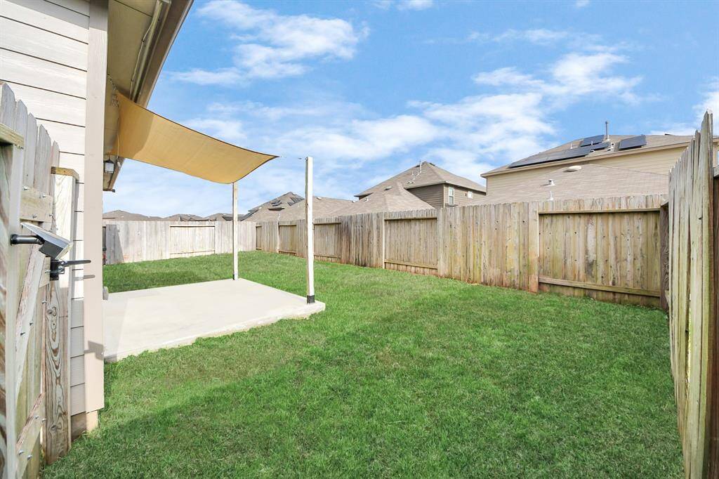 Front and rear sprinklers maintain lush landscaping. 12kW dual-fuel generator provides reliable backup power.  Extended backyard slab with sun sail creates inviting outdoor living space.
