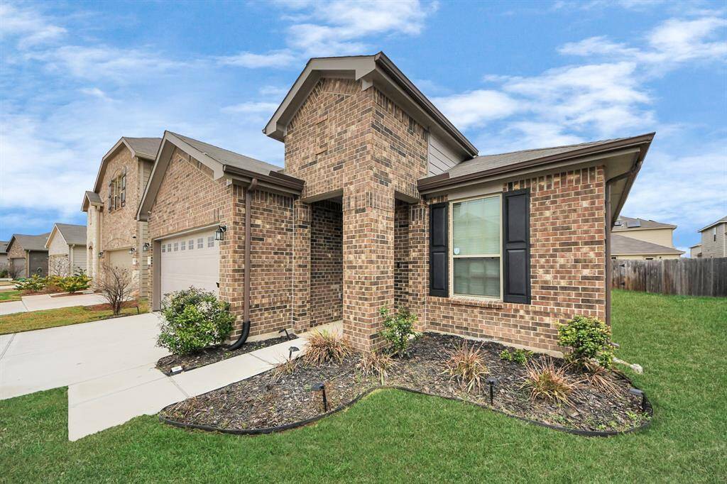 Front and rear sprinklers maintain lush landscaping. 12kW dual-fuel generator provides reliable backup power.  50AMP EV/Tesla charging station caters to modern electric vehicles.  Natural gas hookup offers eco-friendly energy option.  Exquisite custom front door welcomes you in style.