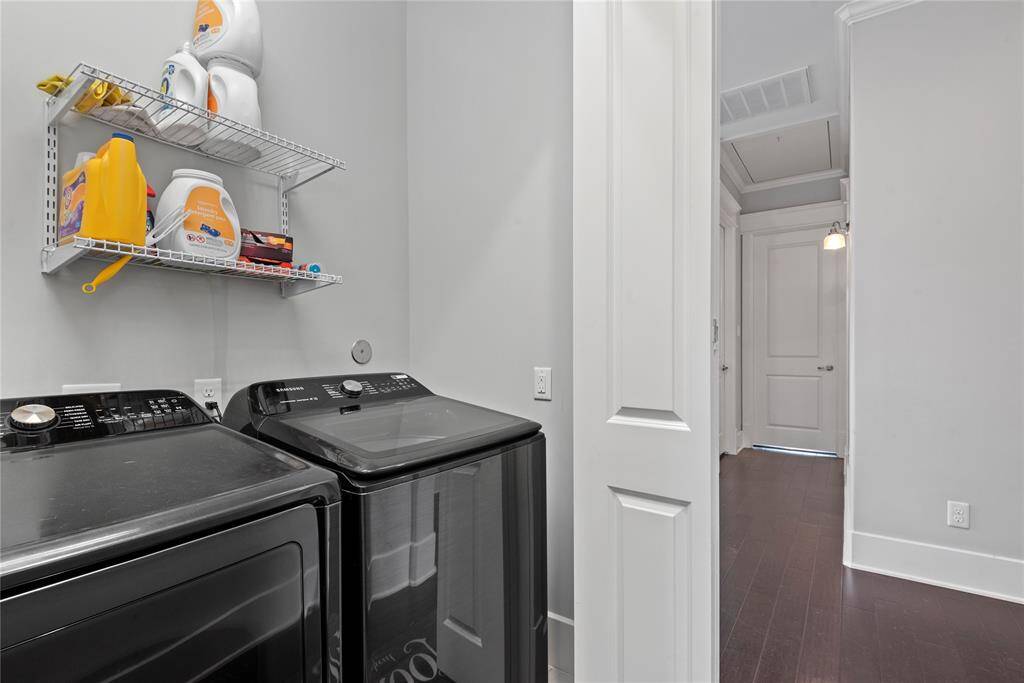 A functional laundry room with ample storage and modern appliances.