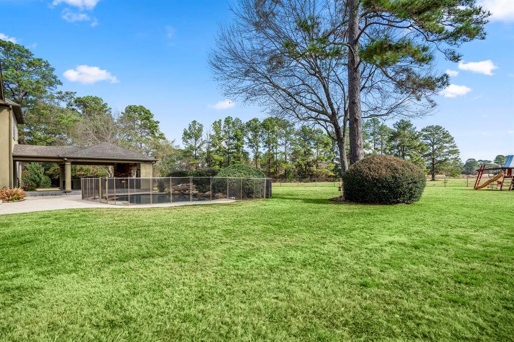 From this vantage point you can  see the back of the pavilion with outdoor kitchen.  This property offers lots of yard with grassy areas that children can  play ball or pets can roam.