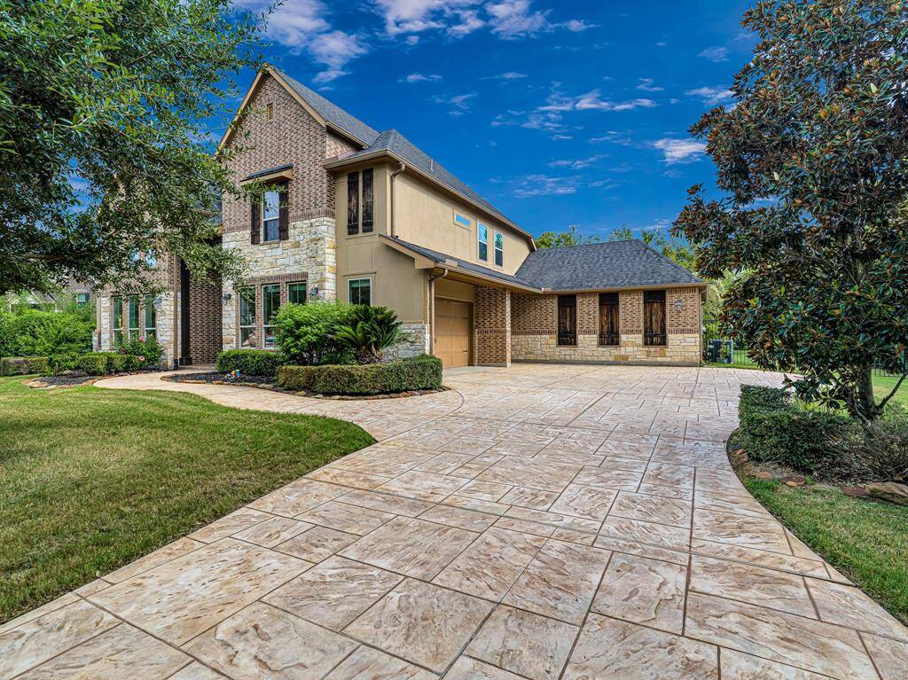 Oversized stamped concrete driveway with 3-car garage
