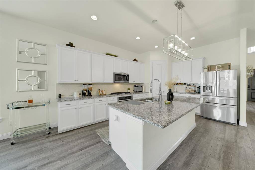 Stunning kitchen with granite countertops, walk-in pantry and lots of cabinet space