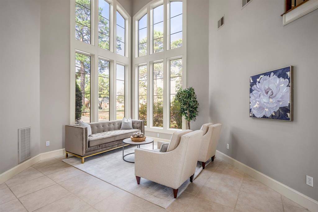 Tall windows invite the outdoors in to your formal living room area, which is another elegant tucked away place to enjoy.