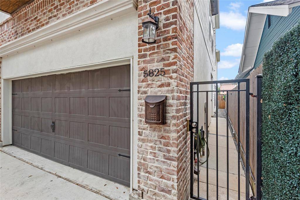 A view of the spacious double car garage, offering ample parking and storage. Gated front door entryway.