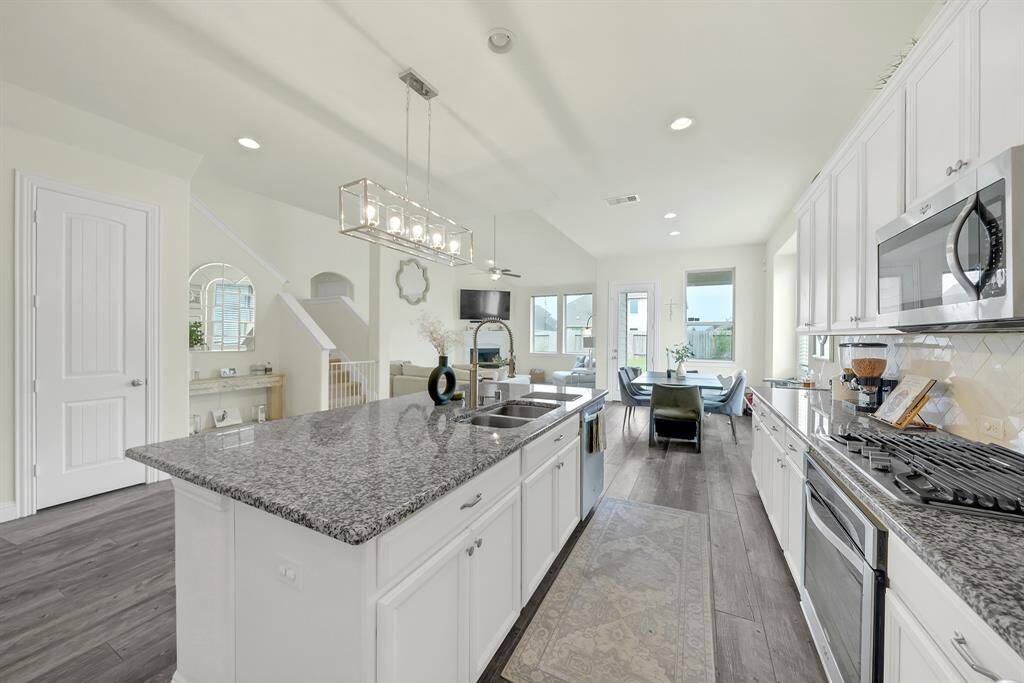 The current owners updated the first floor by removing the carpet and kitchen tile and replacing with this beautiful flooring throughout the first floor