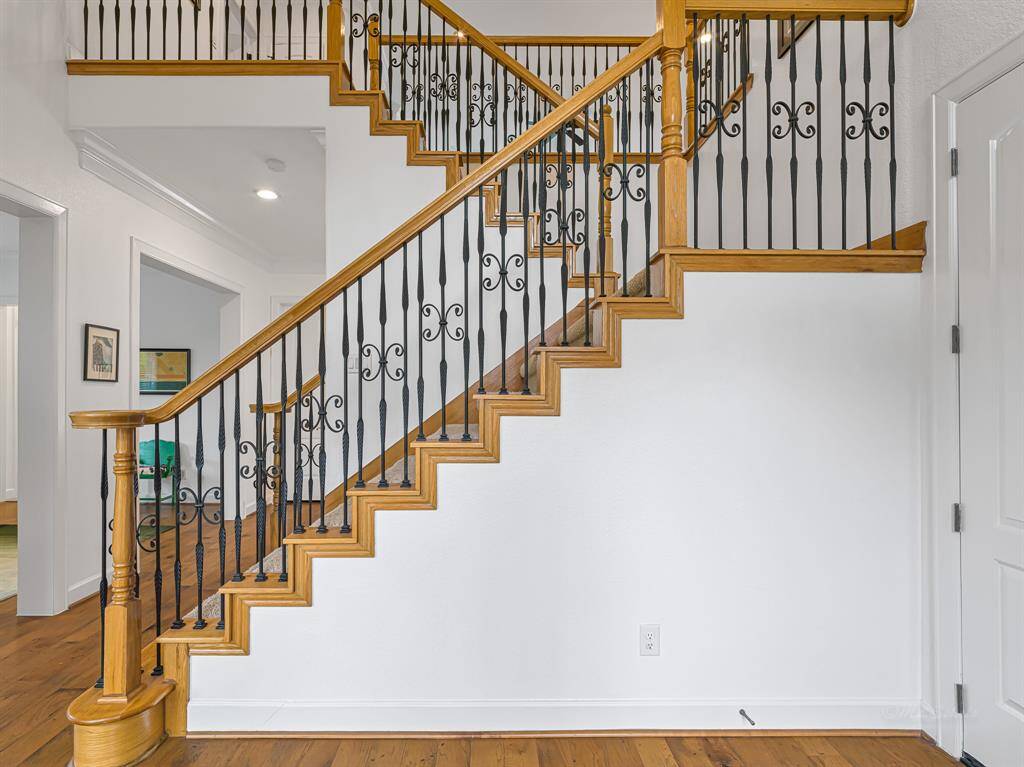Grand entrance foyer with switchback staircare and landing