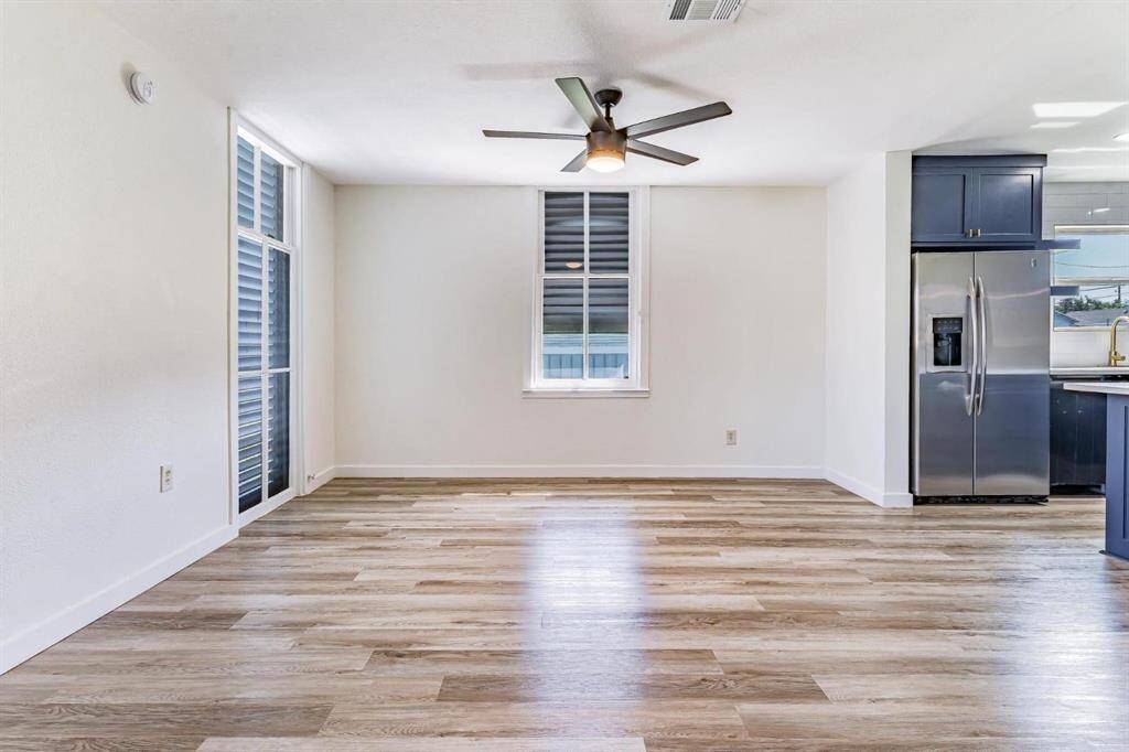 Welcome home to an inviting entryway featuring sleek wood flooring, abundant natural light, and modern finishes.
