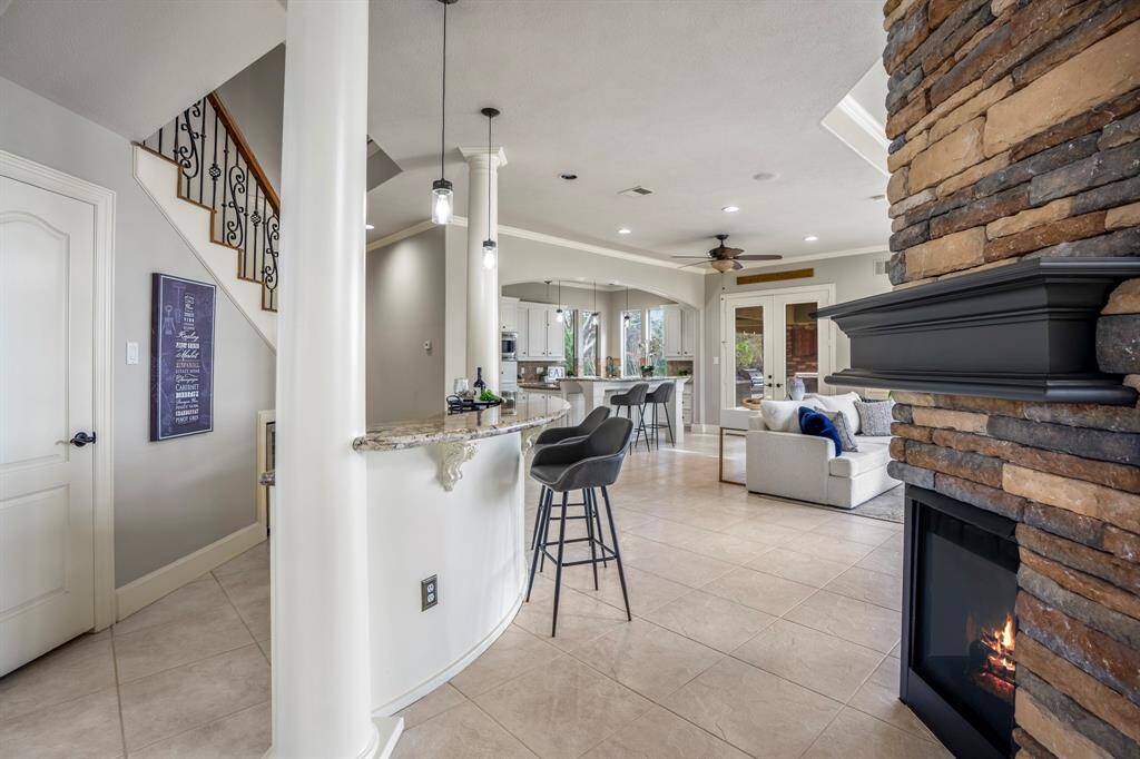 Combine open concept entertaining and everyday living, offering a neutral light and bright open floorplan, leading into the den area, featuring a bricked fireplace to create a warm ambiance.