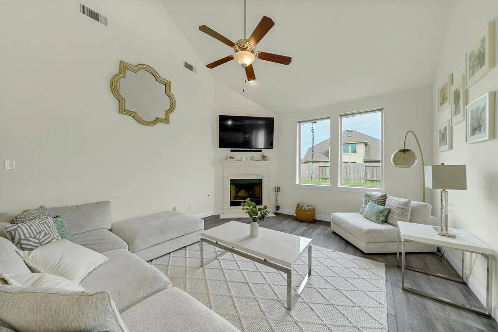 large living room with two story ceilings and an upgraded cast stone firepace