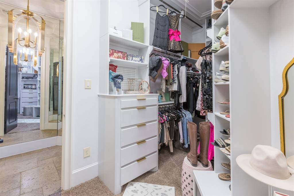 Built-in drawers in closet with floor to ceiling hanging racks