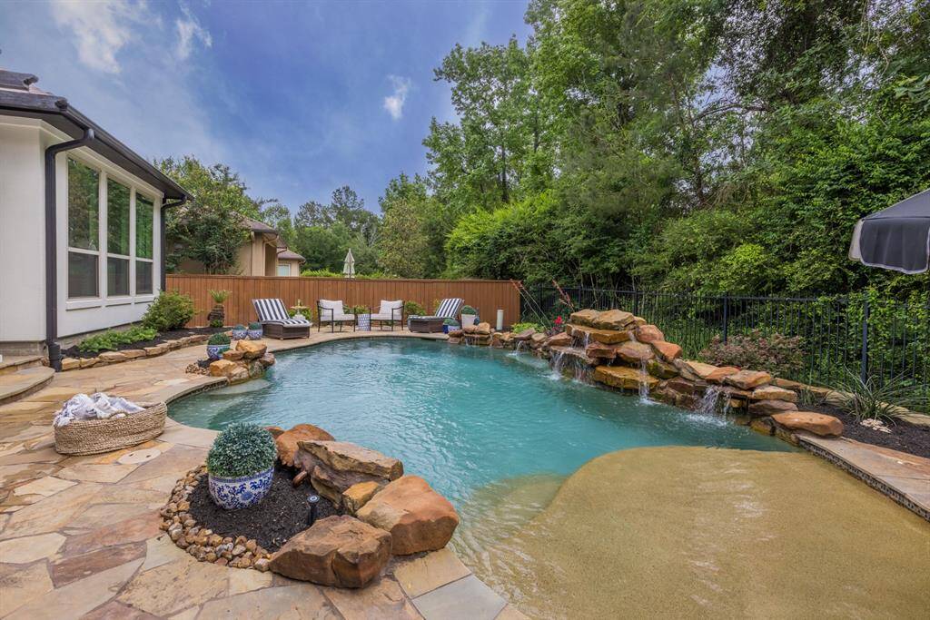Plenty of deck space for lounge chairs and entertainment. Wrought iron back fence with lots of trees and privacy.