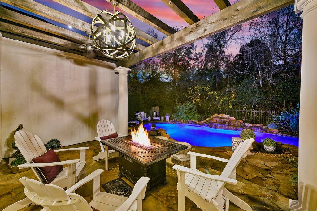 Pergola off covered back porch is perfect for dining and seating area.