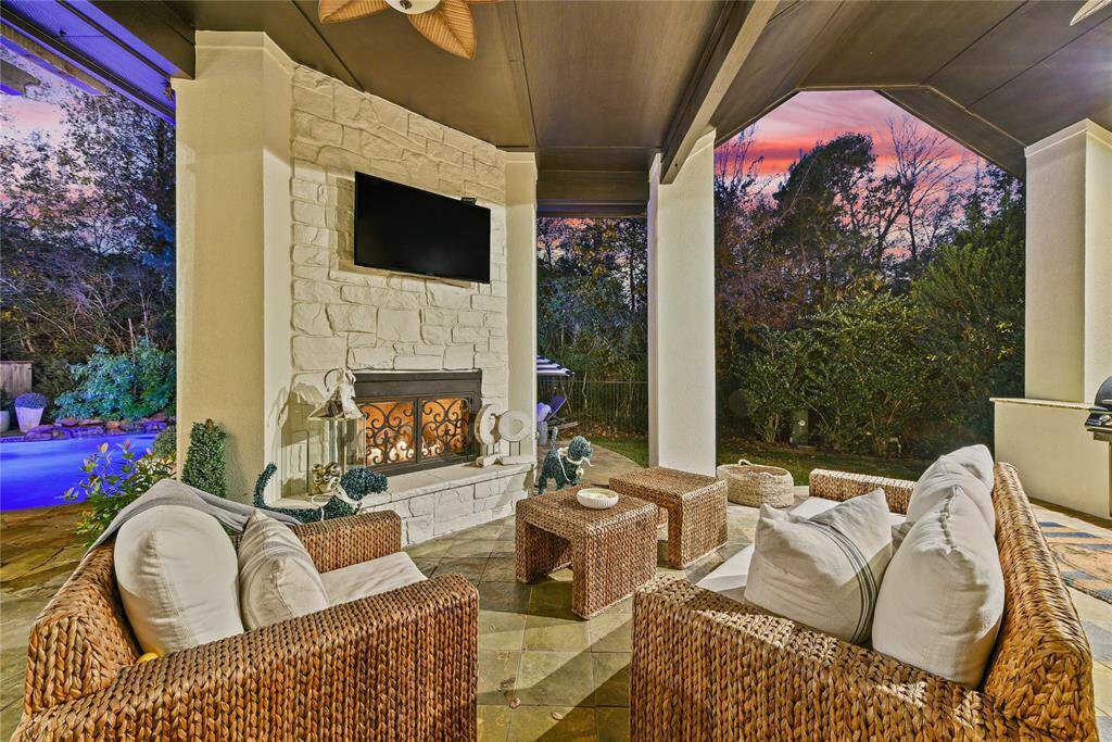 Covered back patio space with stoned fire place. Perfect for year round entertaining!
