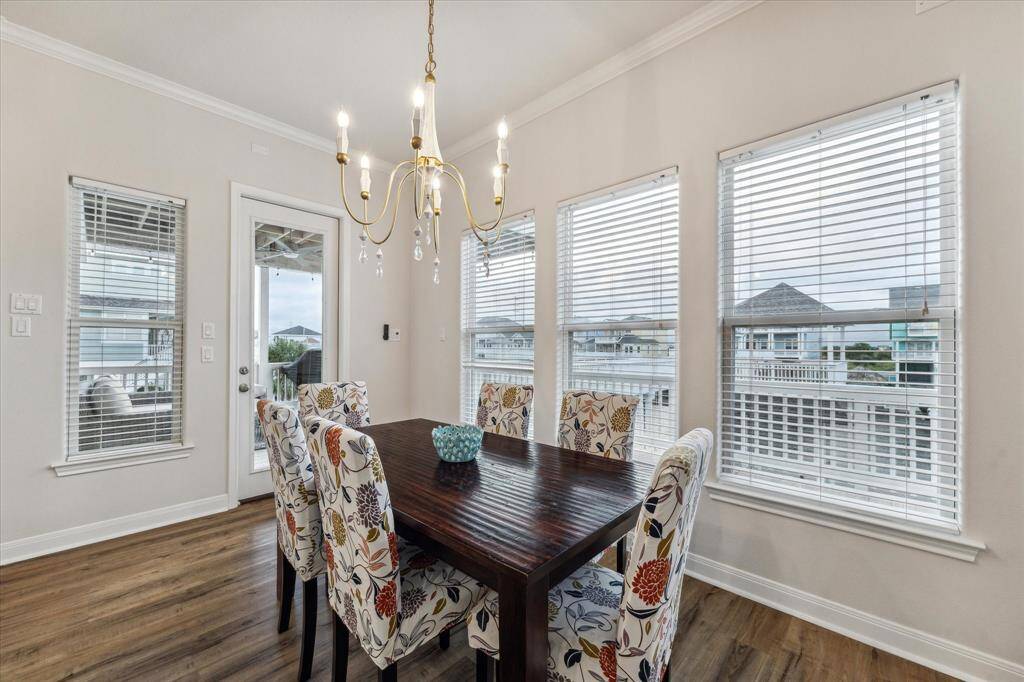 Modern chandelier and spacious dining area . A larger table for 10 would easily fit.