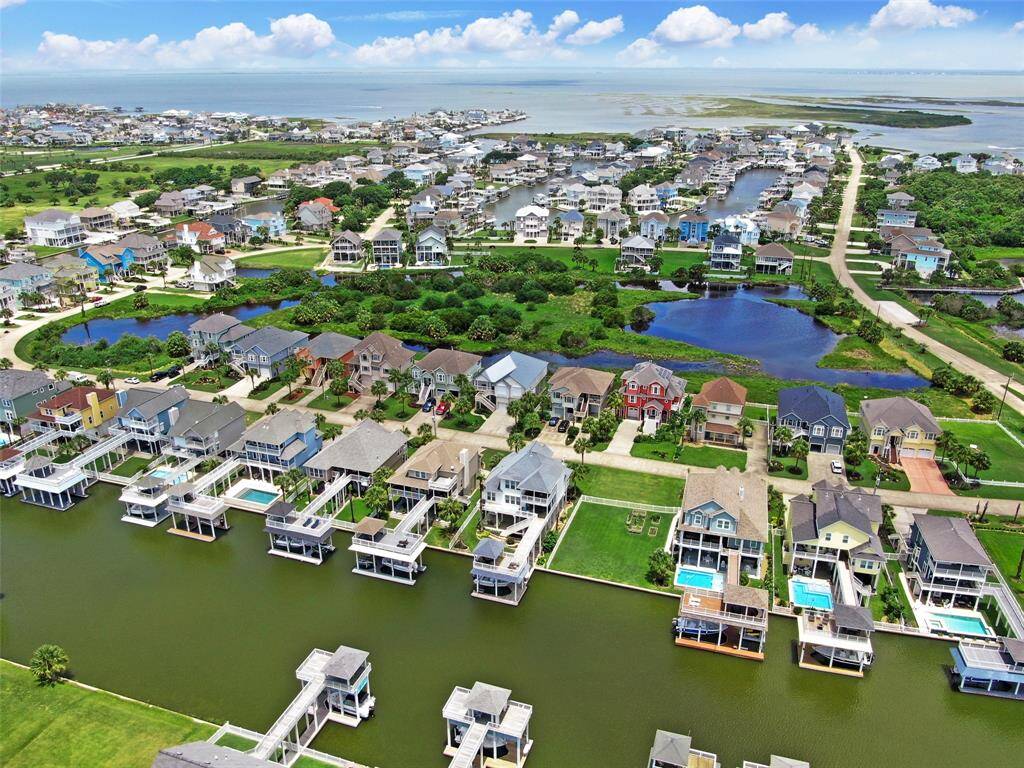 Located on the wide main canal. Views of the blue nature preserve lakes on the north . You're a short hop to the bay by boat or a quick golf cart ride to the beach on the south.