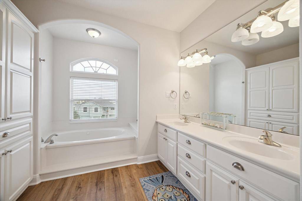 Primary bath features two sink areas, lots of storage and views of nature preserve lakes