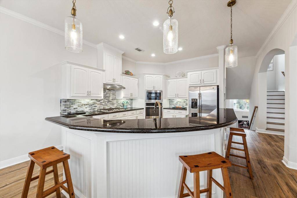 Updated kitchen, updated floors and updated lighting throughout. The bar area seats 6.