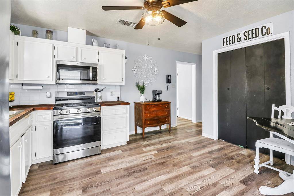Cozy eat-in kitchen featuring stylish butcher block countertops.