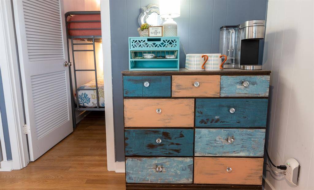 This cozy corner features a colorful coffee bar with extra storage and decorative accents.
