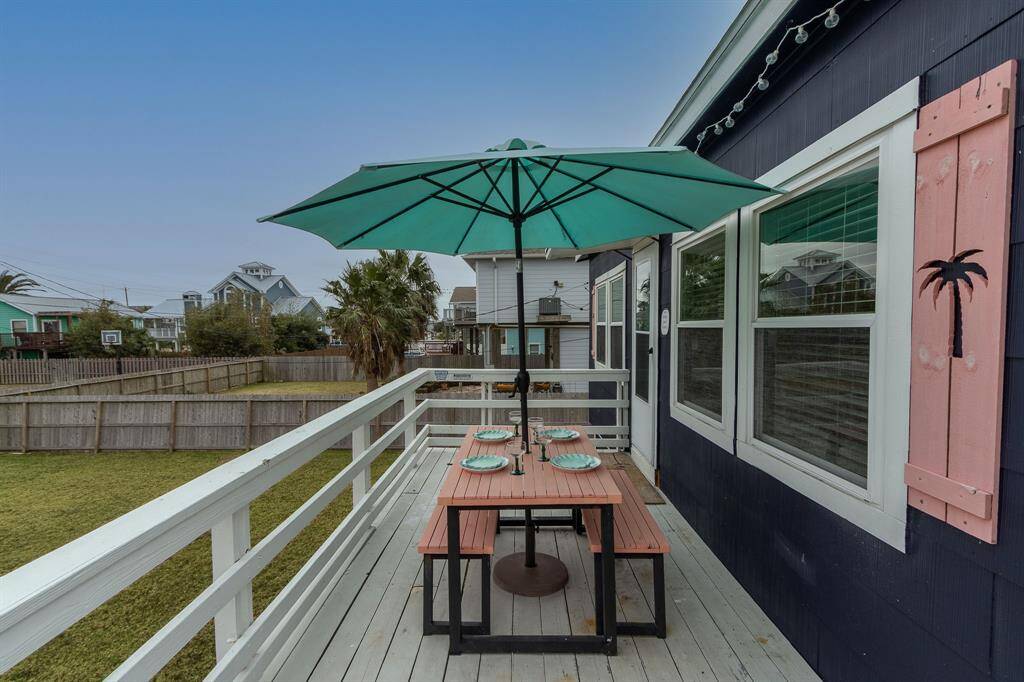 South facing deck with picnic table and umbrella.
