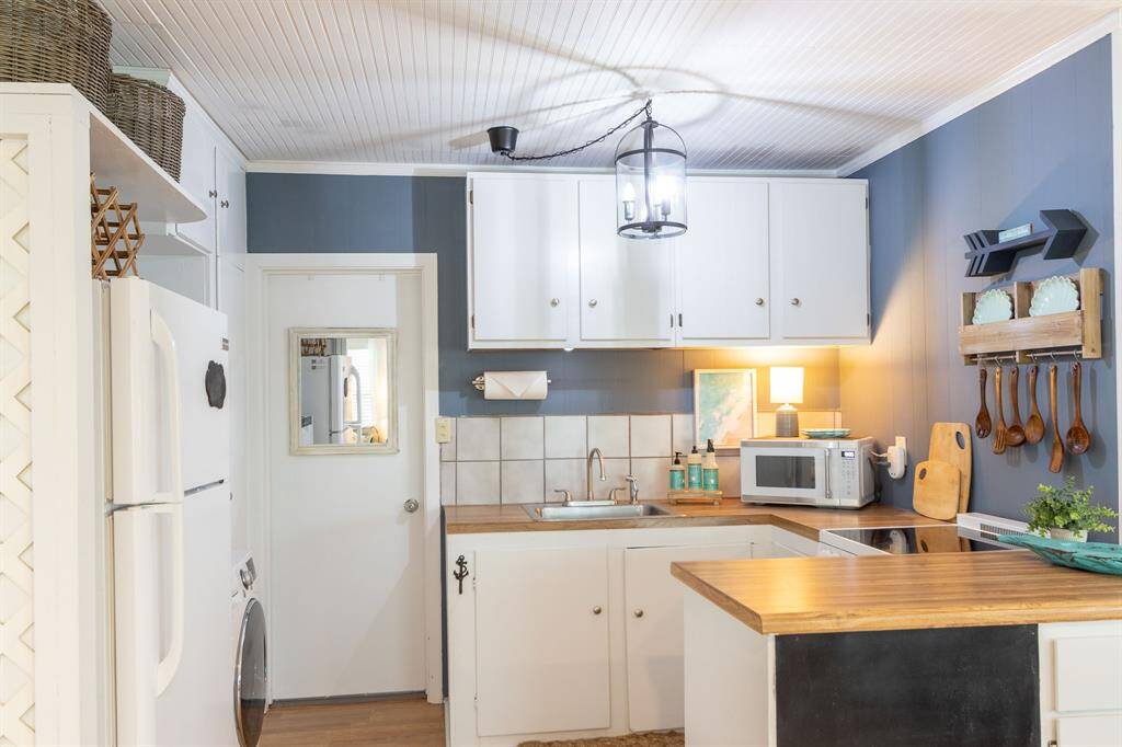 Kitchen has all that you need.  Refrigerator, microwave, dishwasher and washer/dryer all-in-one combo.  Plenty of cabinet space.