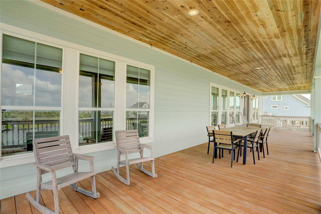 COVERED DECK IS A PERFECT EXTENSION OF THE HOME, OFFERING AMPLE SPACE FOR ENTERTAINING, DINING OR SIMPLY TAKING IN THE PEACEFUL SURROUNDINGS OF THE WATERFRONT COMMUNITY.