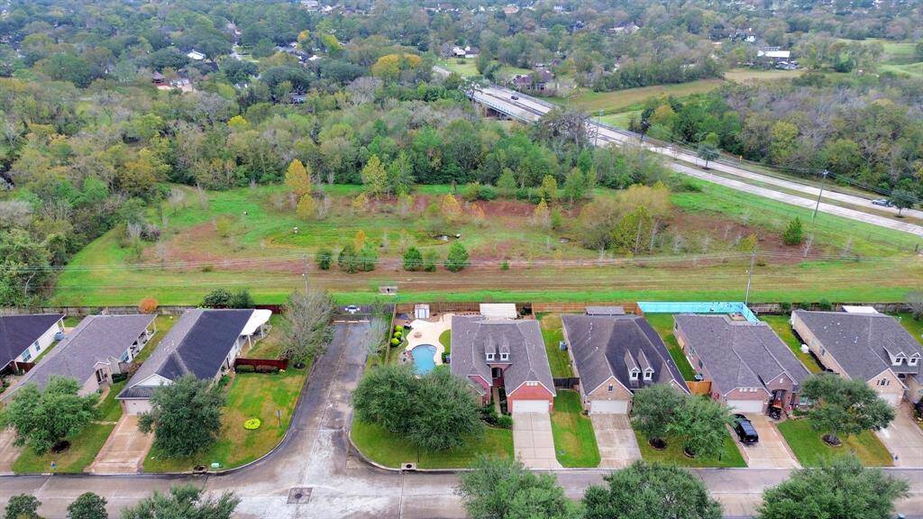 This property sits on a spacious corner lot with direct access to scenic walking trails, surrounded by lush greenery for a tranquil, natural setting.