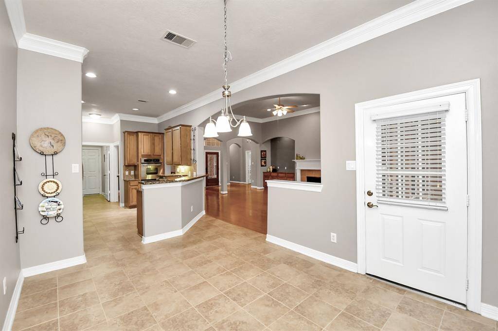 Bright breakfast area with easy access to the covered patio and lush backyard.