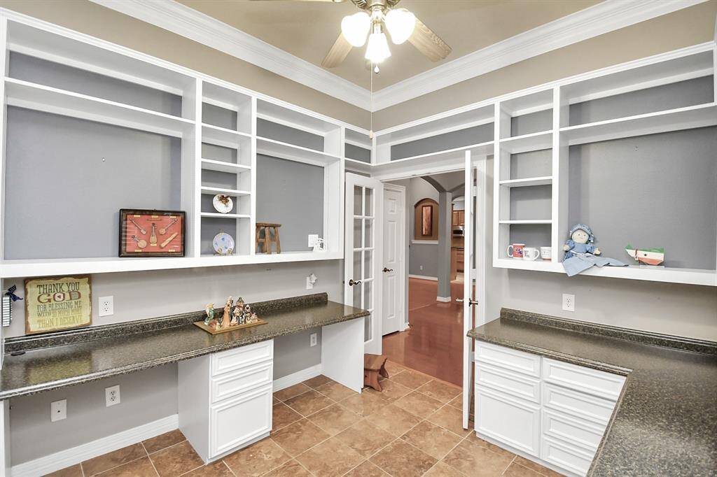 Transform your creativity in this versatile office space, complete with custom built-in shelving and desks—perfect for hobbyists.  This could be used as a bedroom as it does have a closet.