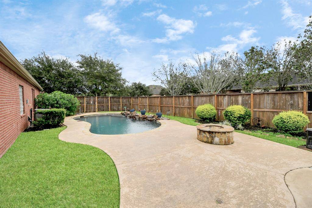 Discover your private oasis with a beautiful pool (installed in 2015), cozy fire pit, and lush landscaping—perfect for memorable gatherings with loved ones.