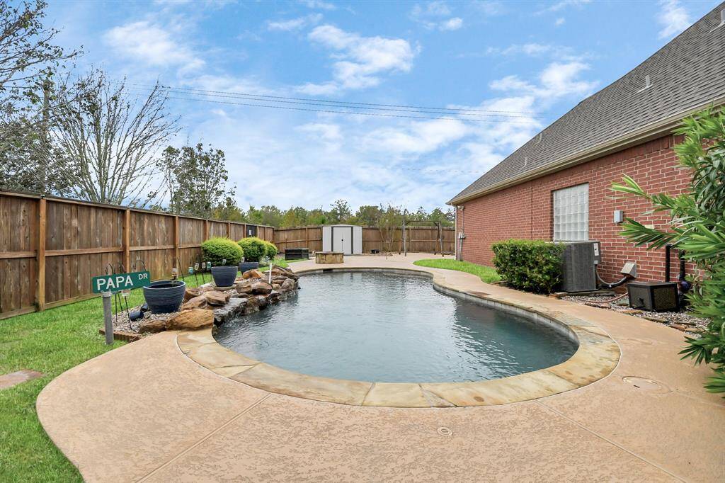Experience ultimate relaxation in this backyard oasis featuring a pool with a stone and concrete deck, plus a cozy fire pit—perfect for gatherings with family and friends.