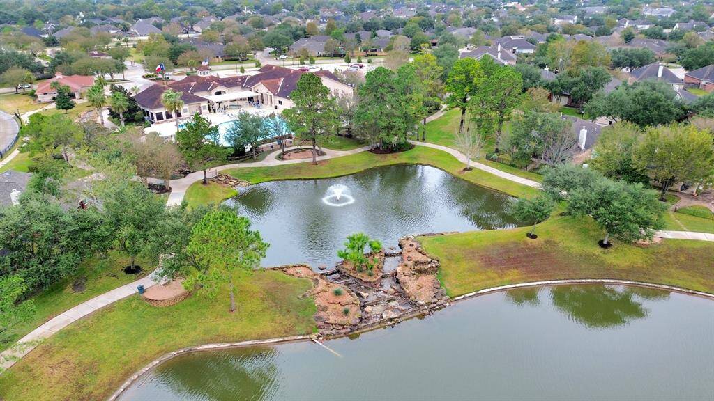 Discover a luxurious community center featuring a spacious pool, hot tub, and abundant lounging areas. Surrounded by lush, well-maintained landscapes, it's perfect for relaxation and social gatherings.