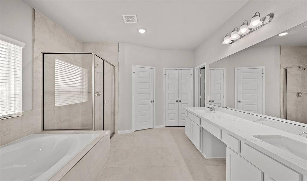 Owner's bath with dual sinks, soaking tub, and separate shower (*Photo not of actual home and used for illustration purposes only.)