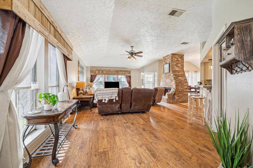 The living space has windows that let in natural light and a great view of the backyard and pool,