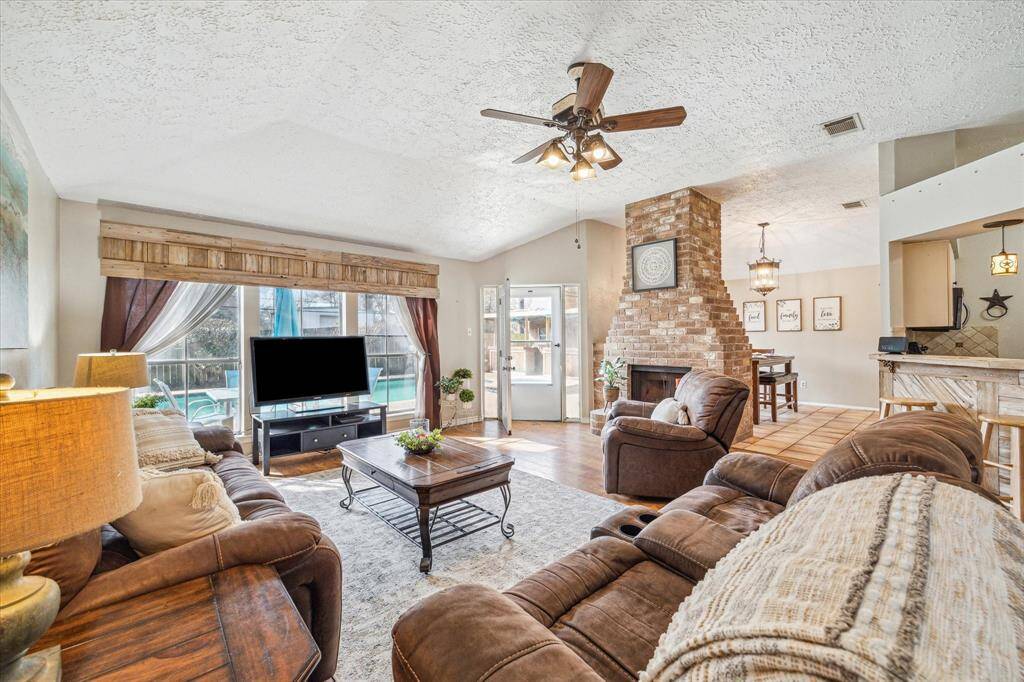 Step into the spacious the living area, featuring ample space and a stunning view of the pool.