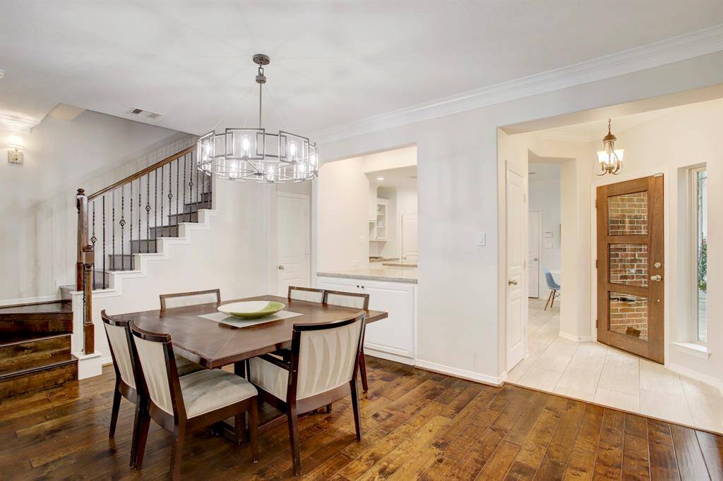 Dining Room - What an entertainer’s dream! The illuminated pass-through wall between the kitchen and dining room is a bonus feature. It can function as a dry bar or an area to display your dishes while dining. The warm and inviting foyer can be seen to the right.